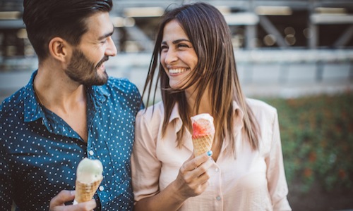 Couple eating ice cream while out for a walk