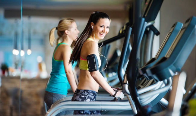 Fitness Center Two female residents exercising on treadmills inside the state-of-the-art fitness center at The Palms of Doral apartments.